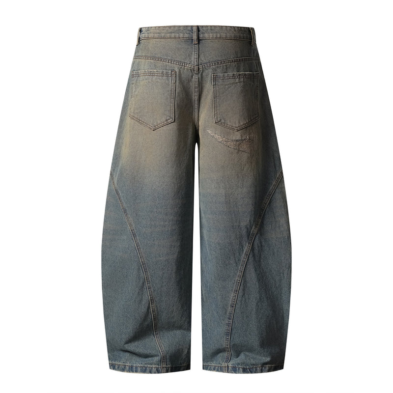Back view of distressed curved wide-leg jeans with patch back pockets