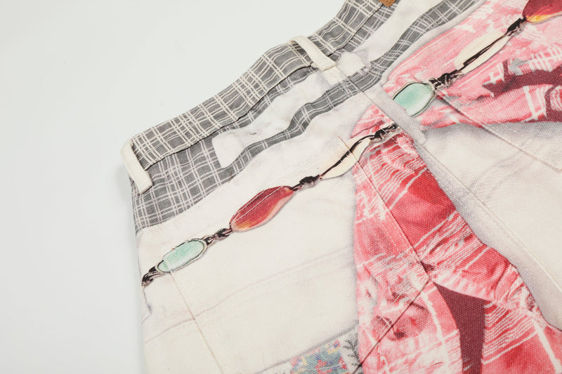 Close-up of upper side seam on gray plaid and pink printed denim pants