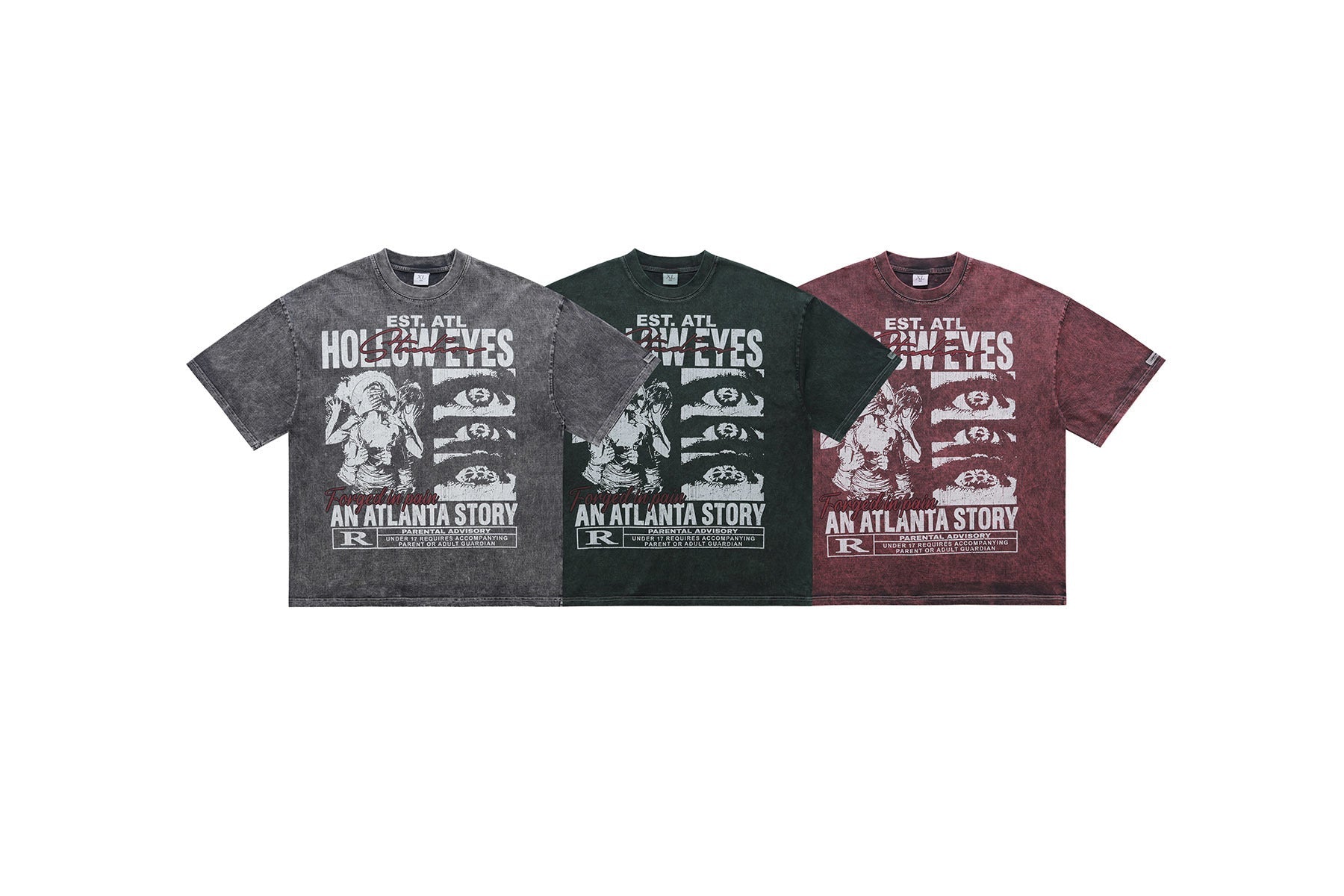 Three acid-washed graphic tees in grey, green, and burgundy featuring Hollow Eyes An Atlanta Story print laid flat on white b