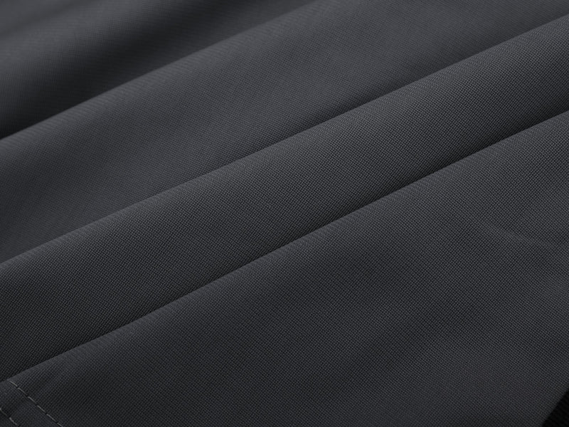 Close-up of gray jersey fabric with smooth and mesh knit texture
