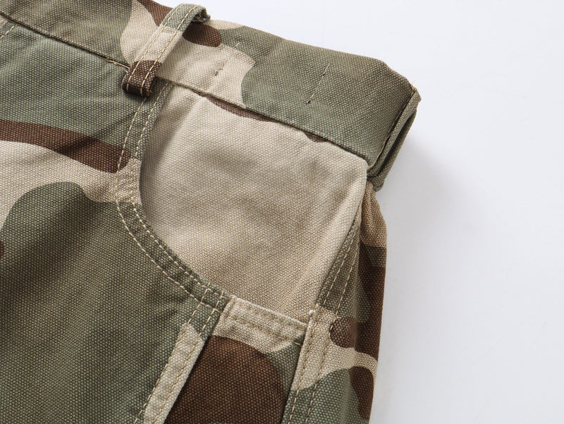 Close-up of camouflage pants front pocket and waistband with visible top stitching