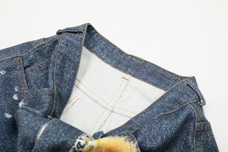 Inside waistband view of blue denim jeans with white lining and stitching