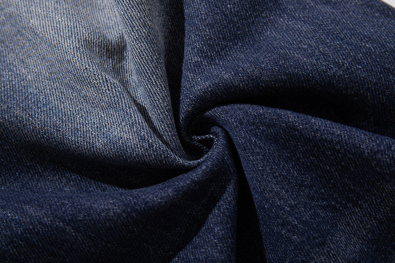 Close-up of twisted blue denim fabric with two-tone fade texture