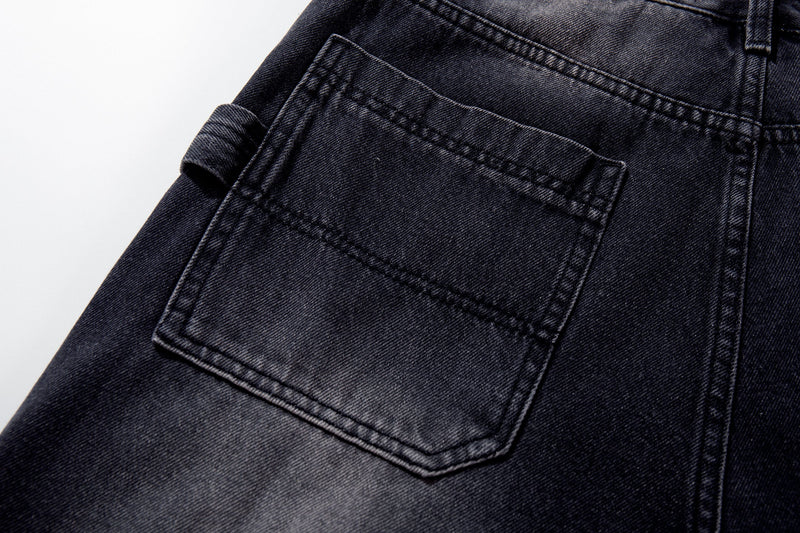 Back pocket close-up of dark wash jeans with paint-like fade detail