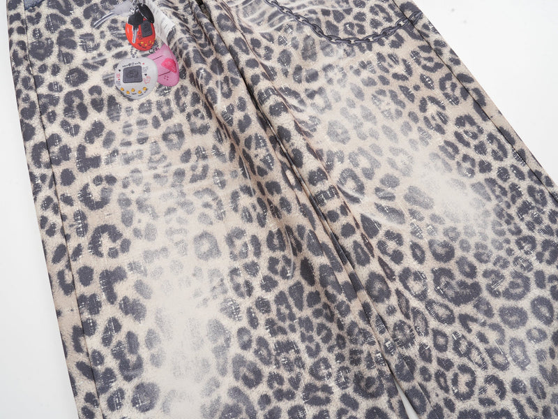 Close-up of wide leopard print leg with hanging charm print and chain graphic