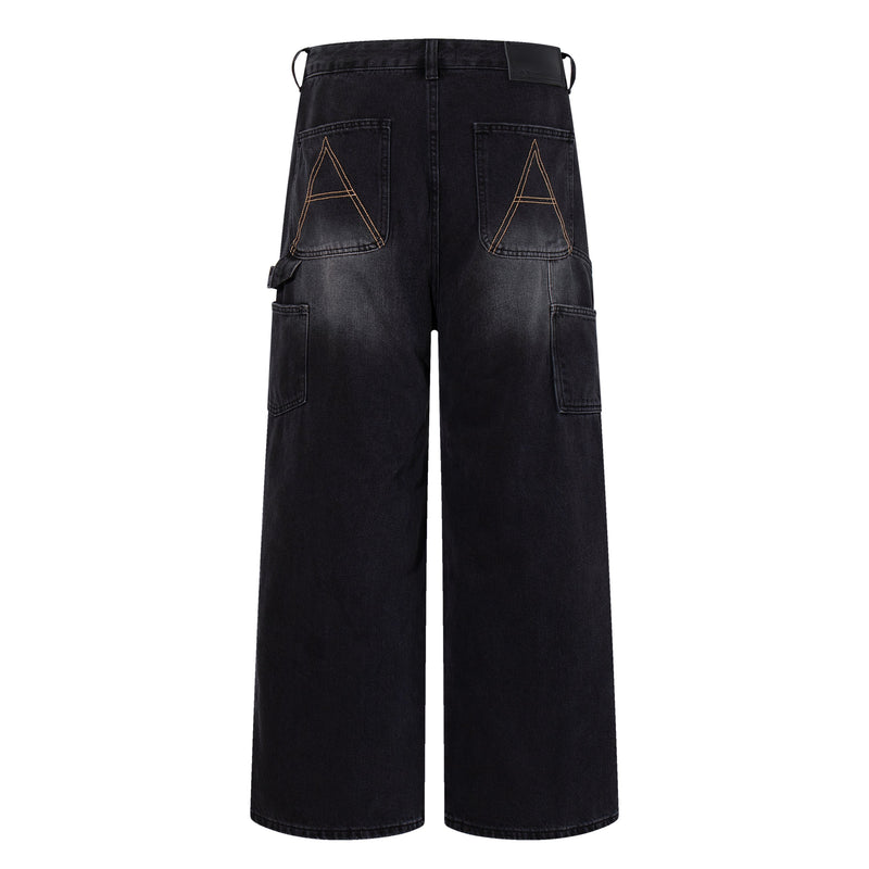 Back view of black wide-leg carpenter jeans with large stitched back pockets and utility loops