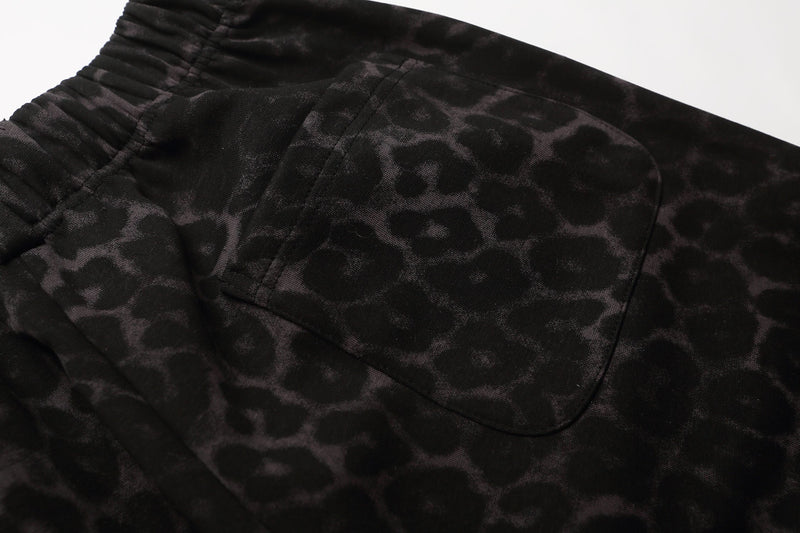 Close-up of black leopard print shorts back pocket and elastic waistband