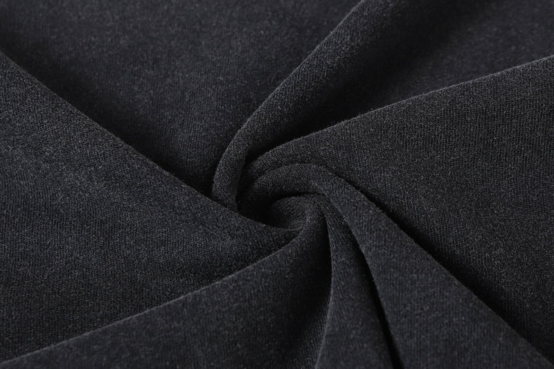 Close-up of black vintage wash tee fabric with soft draped folds