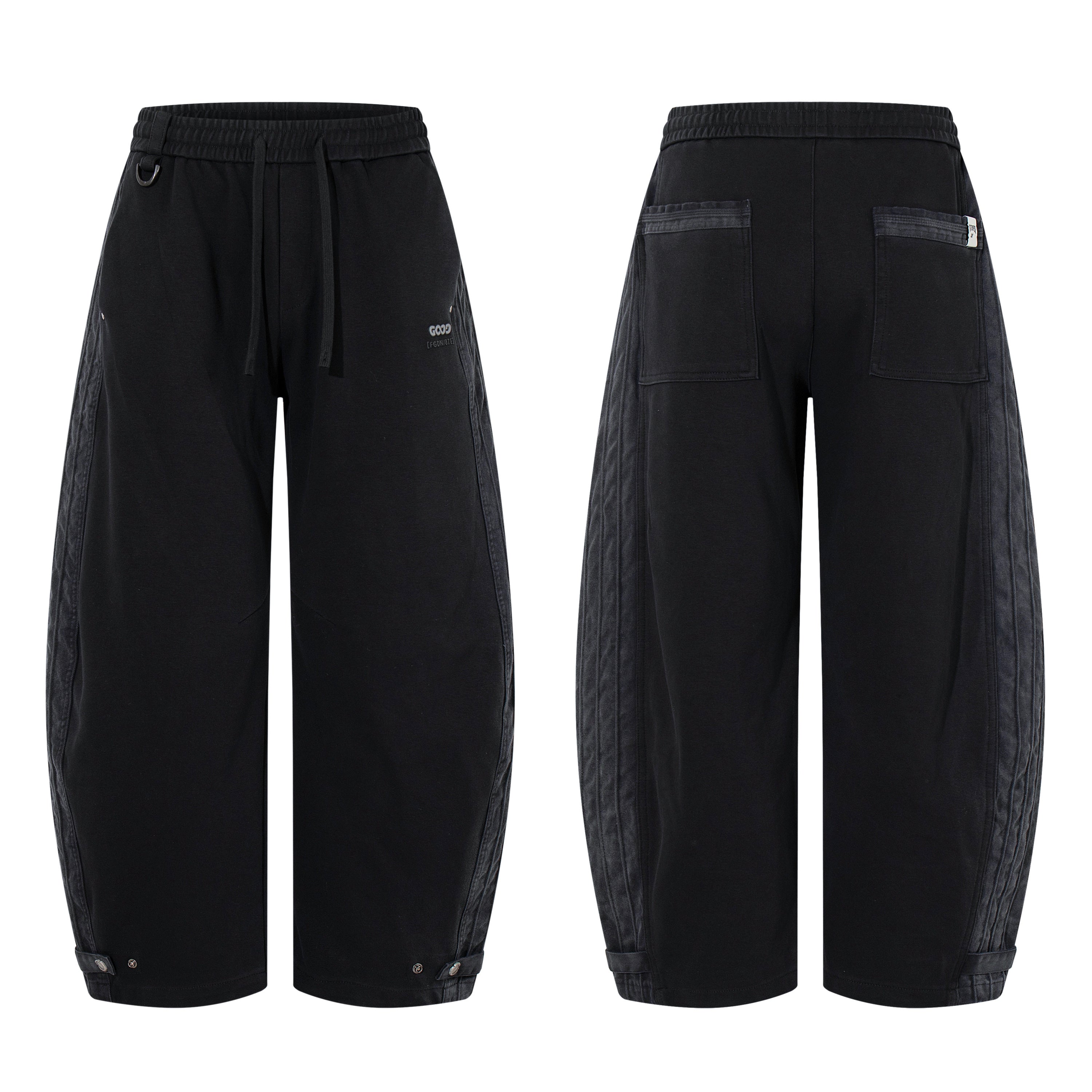 Black barrel-leg utility pants with contrast washed side panels, drawstring waist, and snap-button cuffs, shown front and bac
