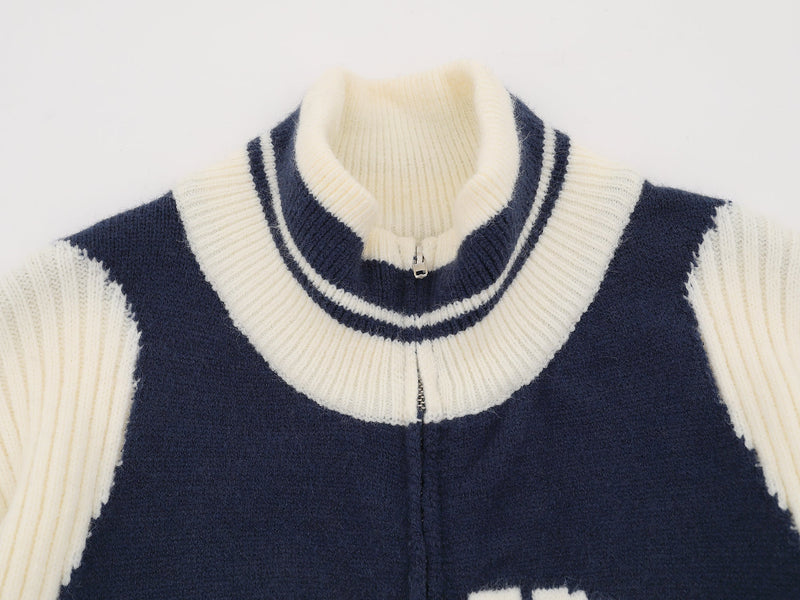 Close-up of cream ribbed collar and navy knit zip front on a varsity jacket
