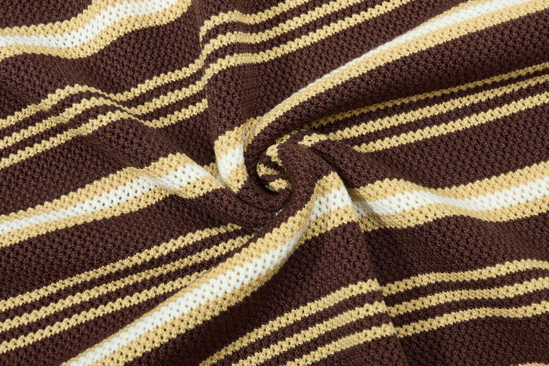 Close-up of a brown knit polo fabric with cream and white retro collegiate stripes and textured woven detail