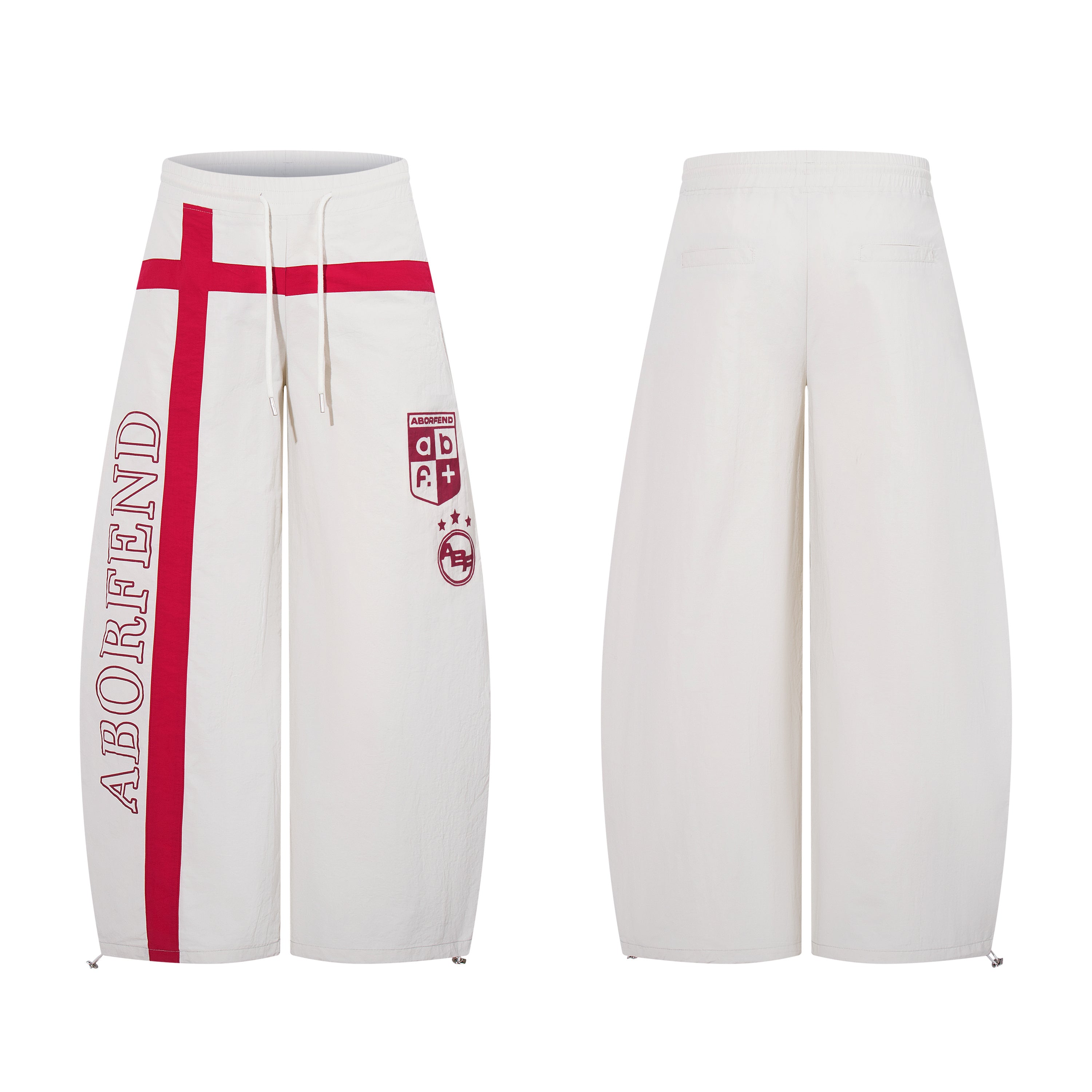 Off-white wide-leg track pants with red cross graphic, vertical brand lettering, and shield crest logo, front and back view
