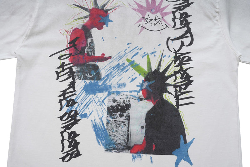 White graphic T-shirt with punk street art collage, abstract figures, star motifs, and bold black lettering