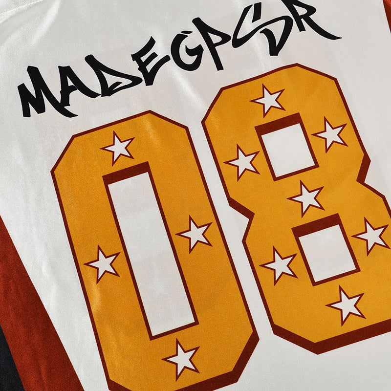 White football jersey with MadeGPSR lettering and large gold number 08 with star accents on the front