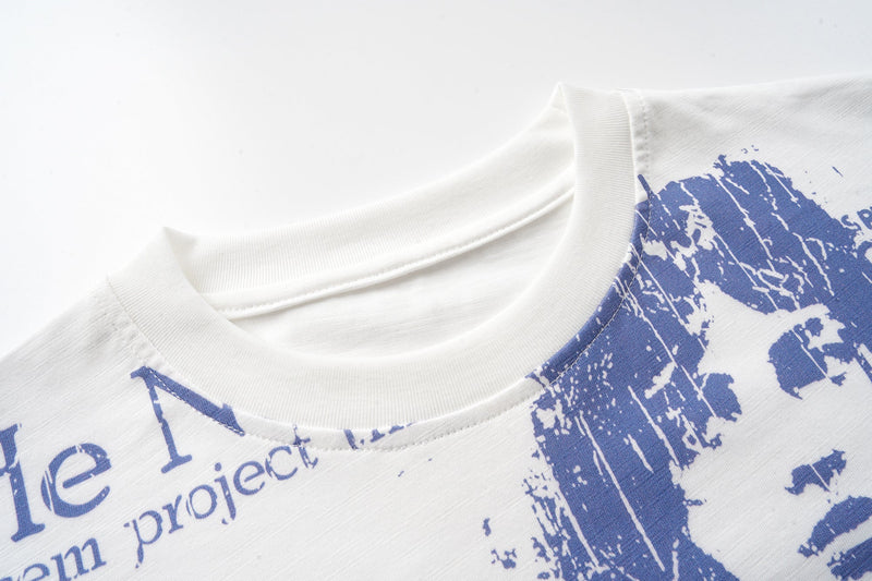 Close-up of off-white crew neck collar with blue graphic print on the chest