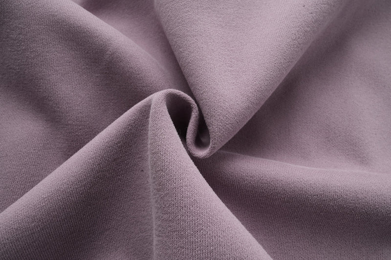 Close-up of lavender hoodie fabric texture and draped folds
