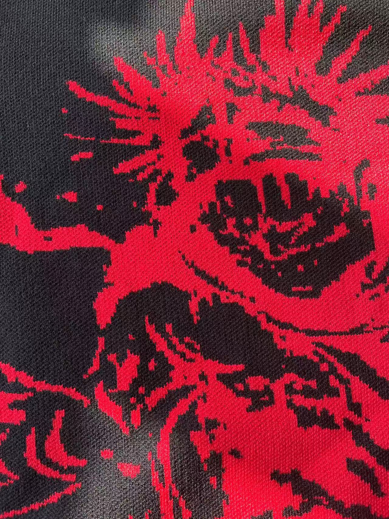 A close-up of the Jujutsu Kaisen Inspired Black Sweatshirt highlights its red cursed energy design, featuring an abstract pattern of sharp, dynamic lines and irregular shapes, capturing the essence of anime streetwear.