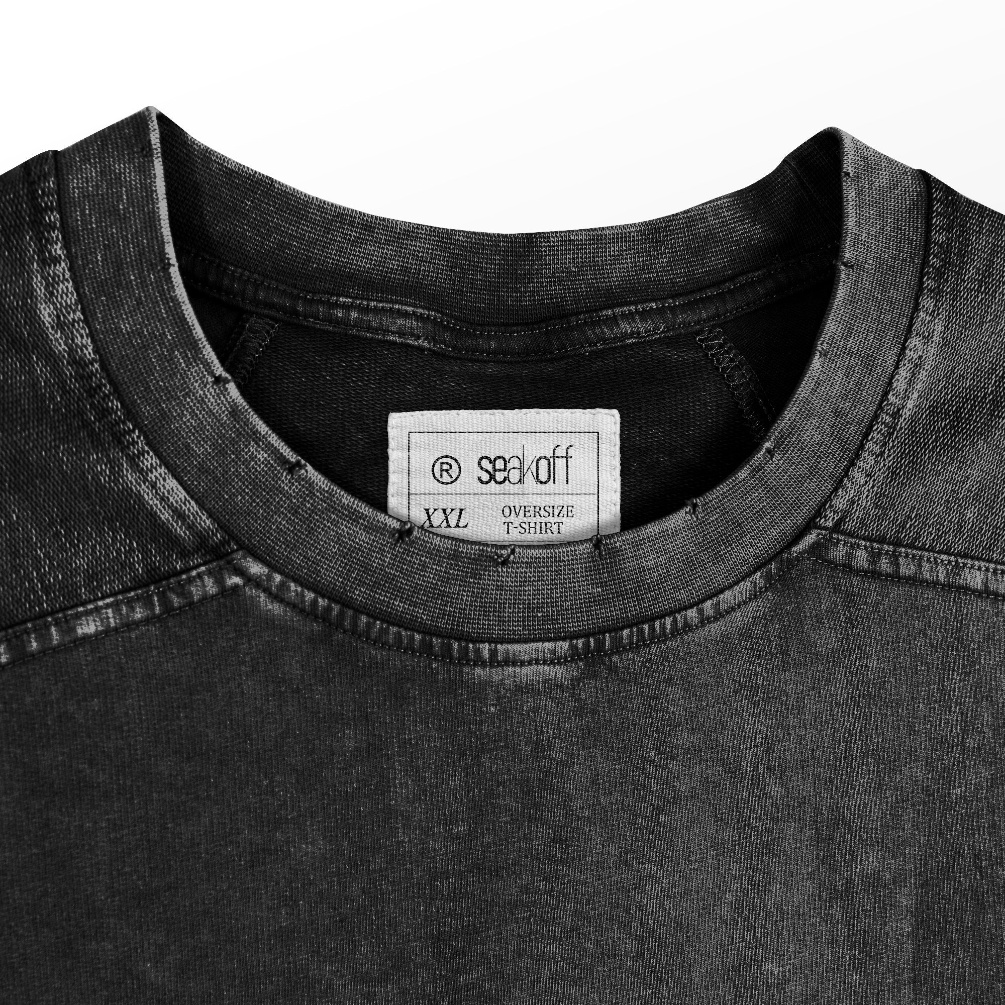 Close-up of a washed black oversized T-shirt by My Hero Academia, featuring a "Plus Ultra!!" Class 1-A design. The neck label reads "seek off," and it's size "XXL," with the worn fabric channeling a heroic charm.