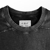 Close-up of a washed black oversized T-shirt by My Hero Academia, featuring a "Plus Ultra!!" Class 1-A design. The neck label reads "seek off," and it&