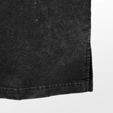 Close-up of the edge of a black denim fabric showcasing its texture, evoking a streetwear vibe akin to the Jujutsu Kaisen Toji Fushiguro&