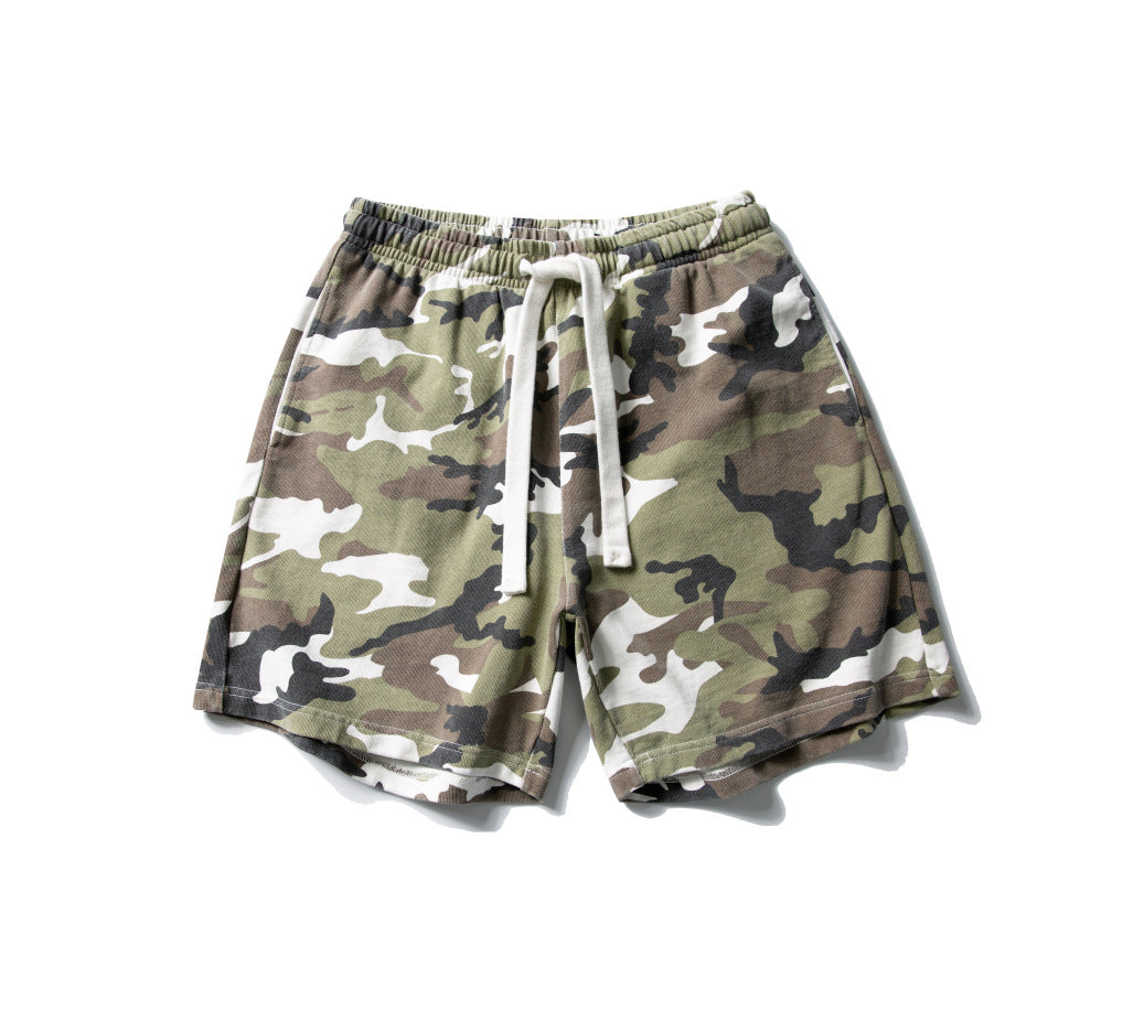 Men's relaxed fit woodland camo shorts with elastic waistband and white cotton drawstring on a white background