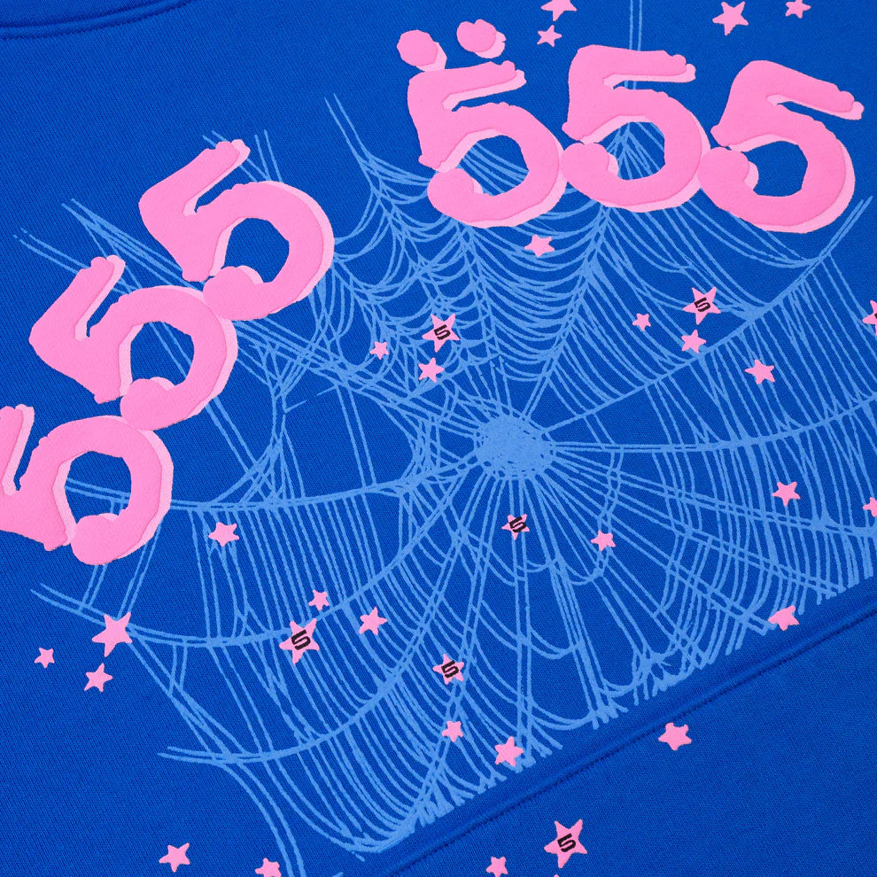 A royal blue Sp5der “555” Hoodie featuring four large pink 555 numbers above a pale spiderweb pattern, with small pink stars and S symbols—perfect for fans of standout heavyweight streetwear pullovers.