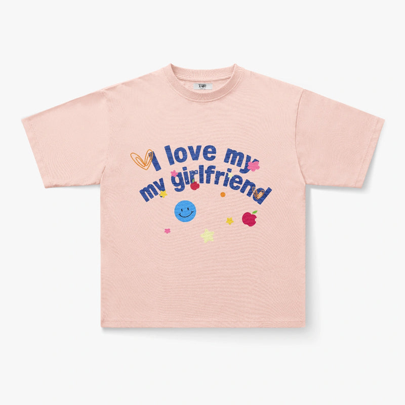 The "I Love My Girlfriend" Embroidered Doodle Graphic Oversized Black Tee features playful colorful designs—yellow heart, blue smiley face, pink star, and red apple—perfect for showing off your fun Y2K-inspired style.