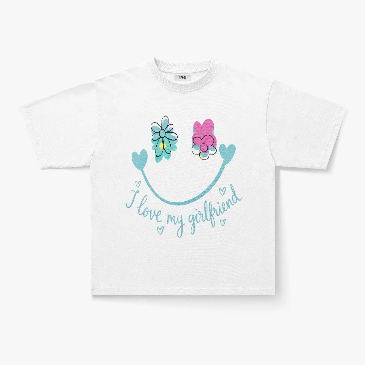 The I Love My Girlfriend Smiley Face Floral Graphic Oversized T-Shirt features a large blue smiley face with flower eyes and blue hearts, making it a perfect way to spread good vibes and show your affection.