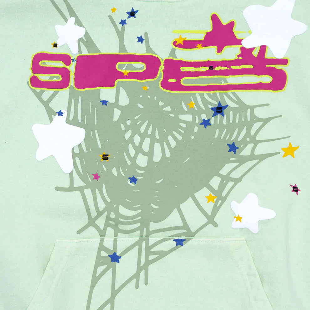 The Sp5der “Mint Star Web” Hoodie is a mint green 440GSM heavyweight oversized streetwear pullover featuring a gray spiderweb, white and yellow stars, blue and orange S letters, and large pink SPEE text.