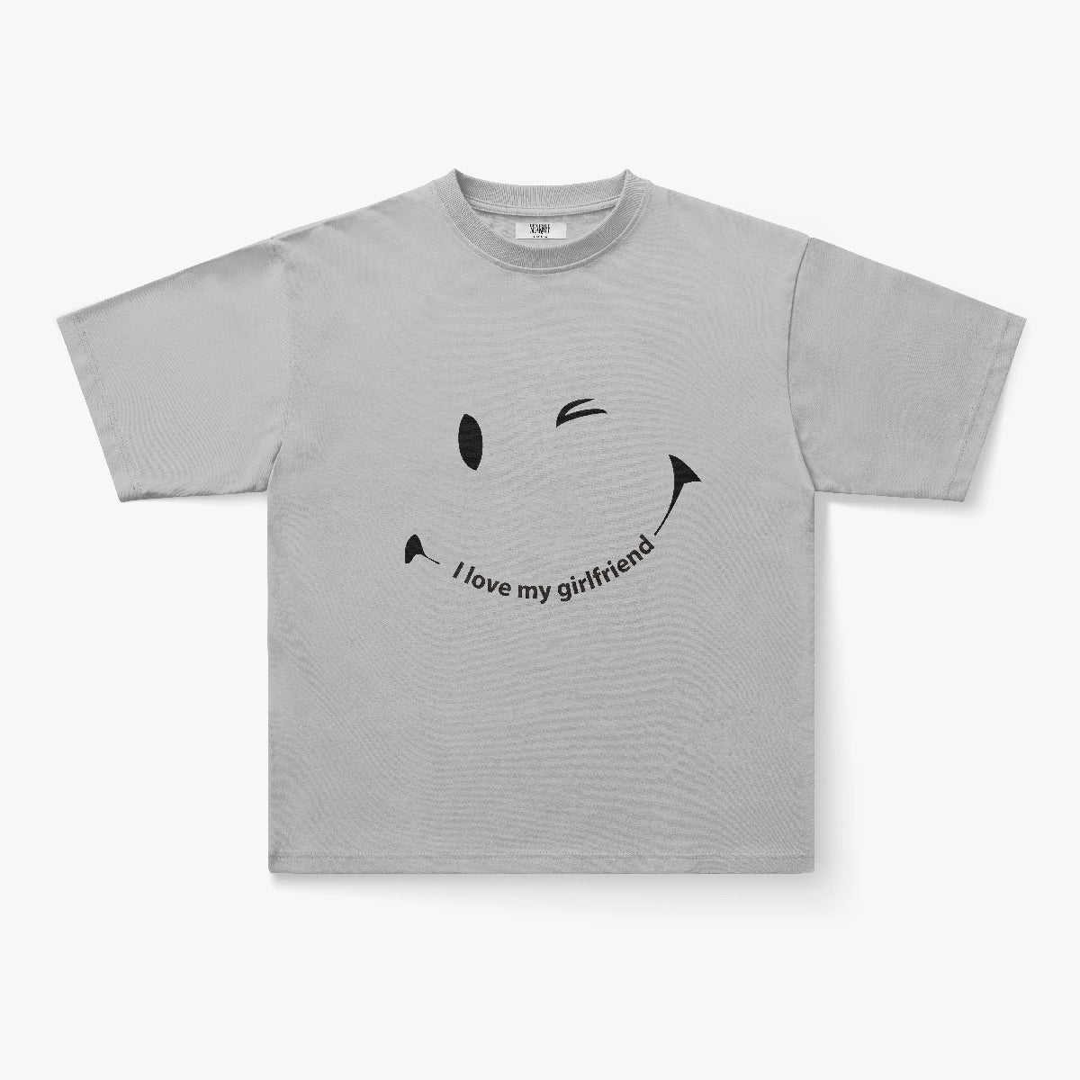 The I Love My Girlfriend Winking Smiley Face Oversized Graphic Tee is a light gray streetwear shirt with a bold smiley and curved text, perfect for couples seeking playful Y2K-inspired style.