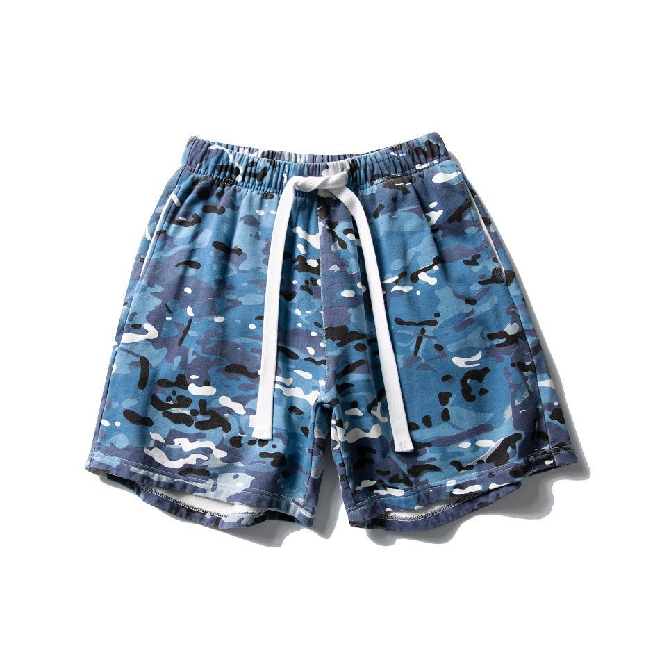 Men's relaxed fit blue camouflage shorts with white drawstring elastic waistband and side pockets laid flat on white background