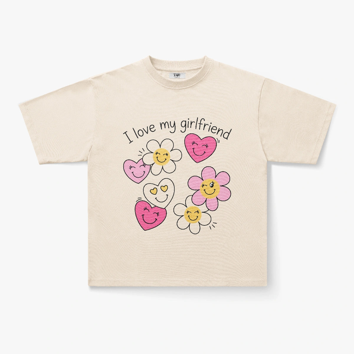 The I Love My Girlfriend Smiley Heart Daisy Graphic Print T-Shirt is a beige oversized tee with "I Love My Girlfriend" and cartoon pink and yellow flowers and hearts on the front, offering a playful Y2K vibe.