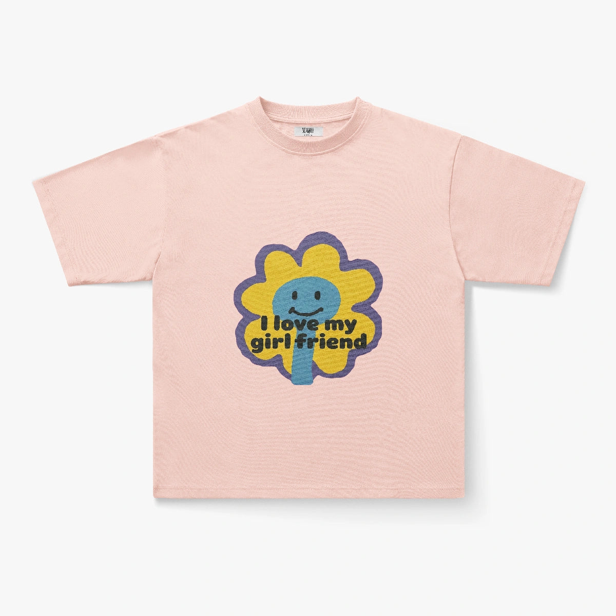 The I Love My Girlfriend Retro Flower Smiley Graphic Oversized Tee is a blush pink shirt with a large cartoon flower and cheerful text—ideal for fans of daisy graphics, Y2K indie style, and playful streetwear looks.