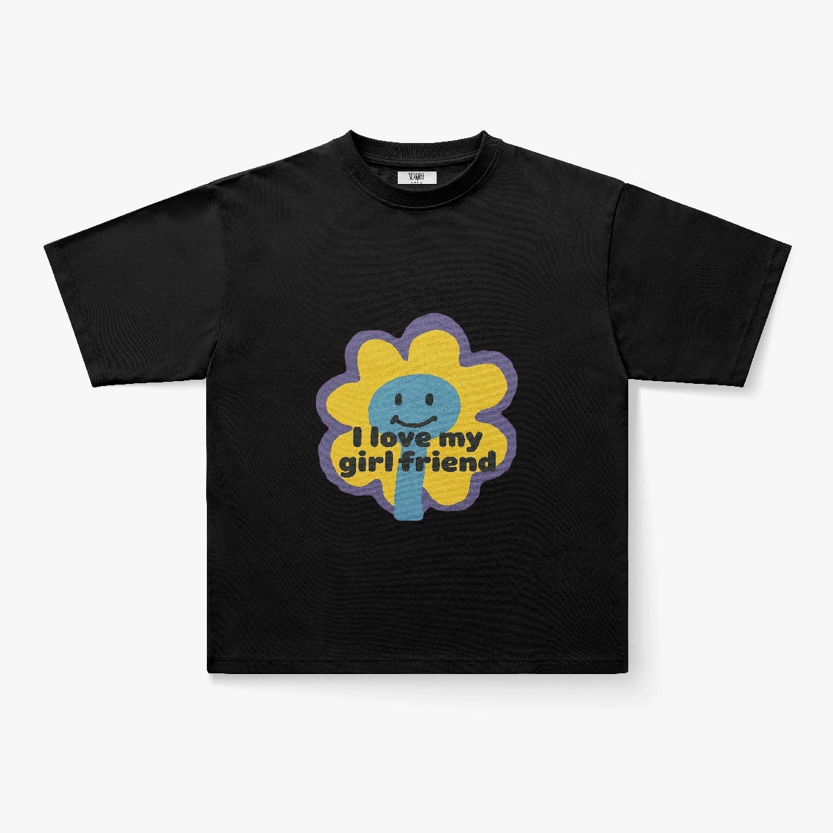 The I Love My Girlfriend Retro Flower Smiley Graphic Oversized Tee is a black shirt with a cartoon daisy, smiling face, and yellow “I love my girlfriend” text across the flower.