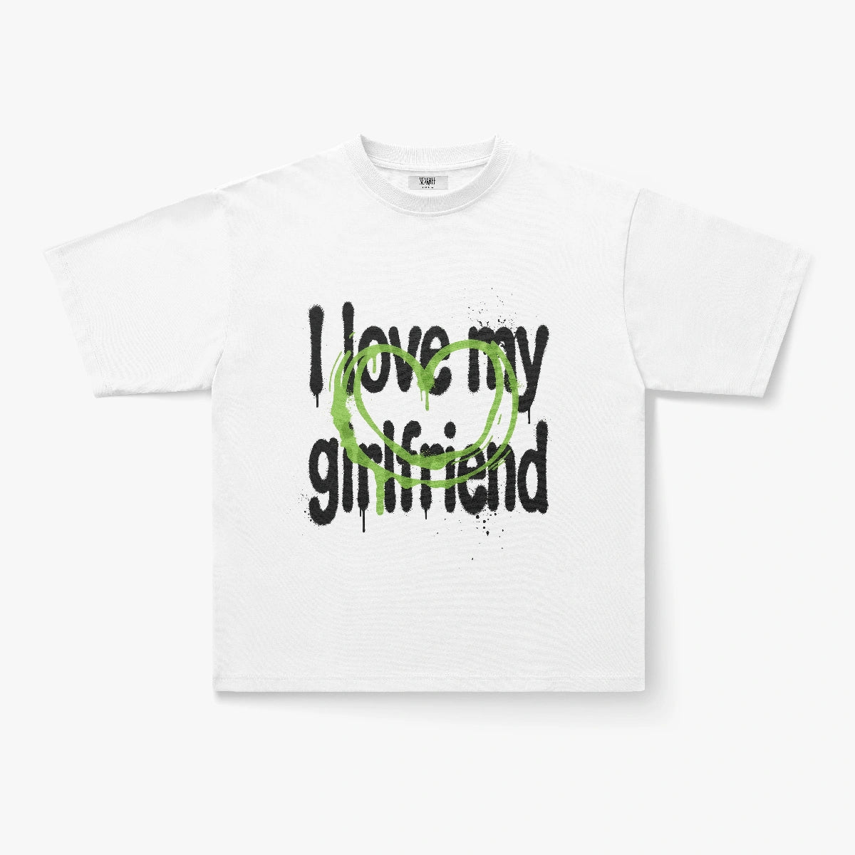 The I Love My Girlfriend Graffiti Heart Graphic Oversized White Tee is a heavyweight cotton streetwear shirt with bold black text and a large green heart, perfect for making a statement.