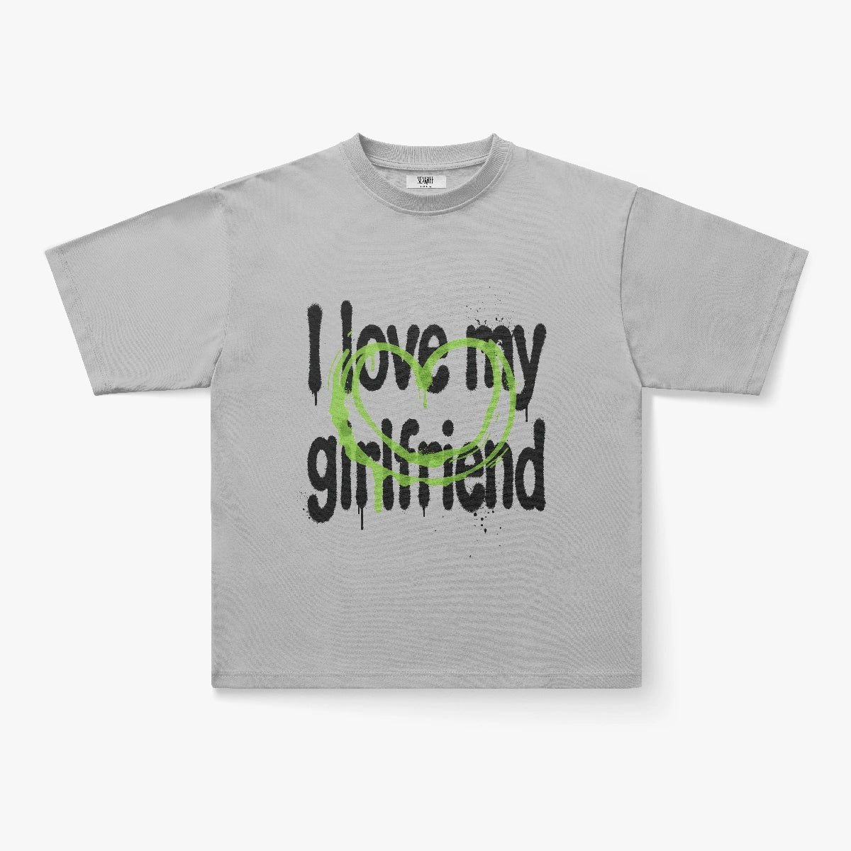 The I Love My Girlfriend Graffiti Heart Graphic Oversized White Tee features black text and a green sprayed heart, ideal for streetwear fans who love bold graphic t-shirts.
