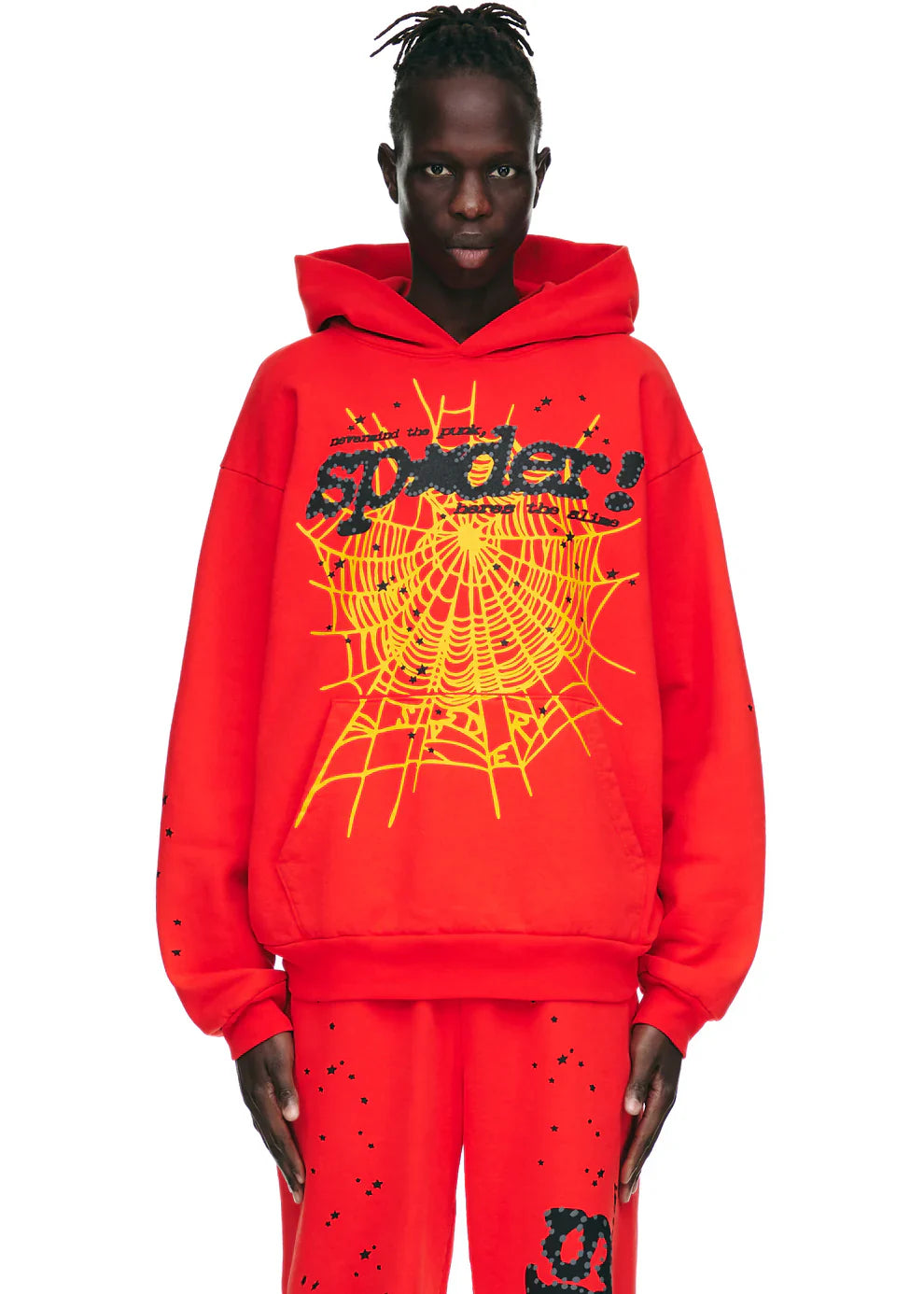 A person wears the Red Graphic Hoodie with Spider Web Print and Star Details – a comfort fit pullover featuring bold yellow spiderweb graphics and "spider!" text, making a striking streetwear statement.