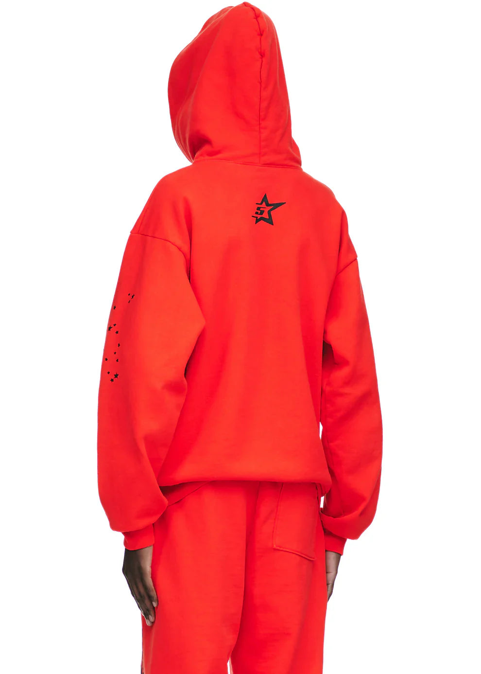 Person wearing the Red Graphic Hoodie with Spider Web Print and Star Details – Comfort Fit Pullover Hoodie, seen from the back. The hoodie shows a black star on the upper back and black dots on the left sleeve for a bold streetwear look.