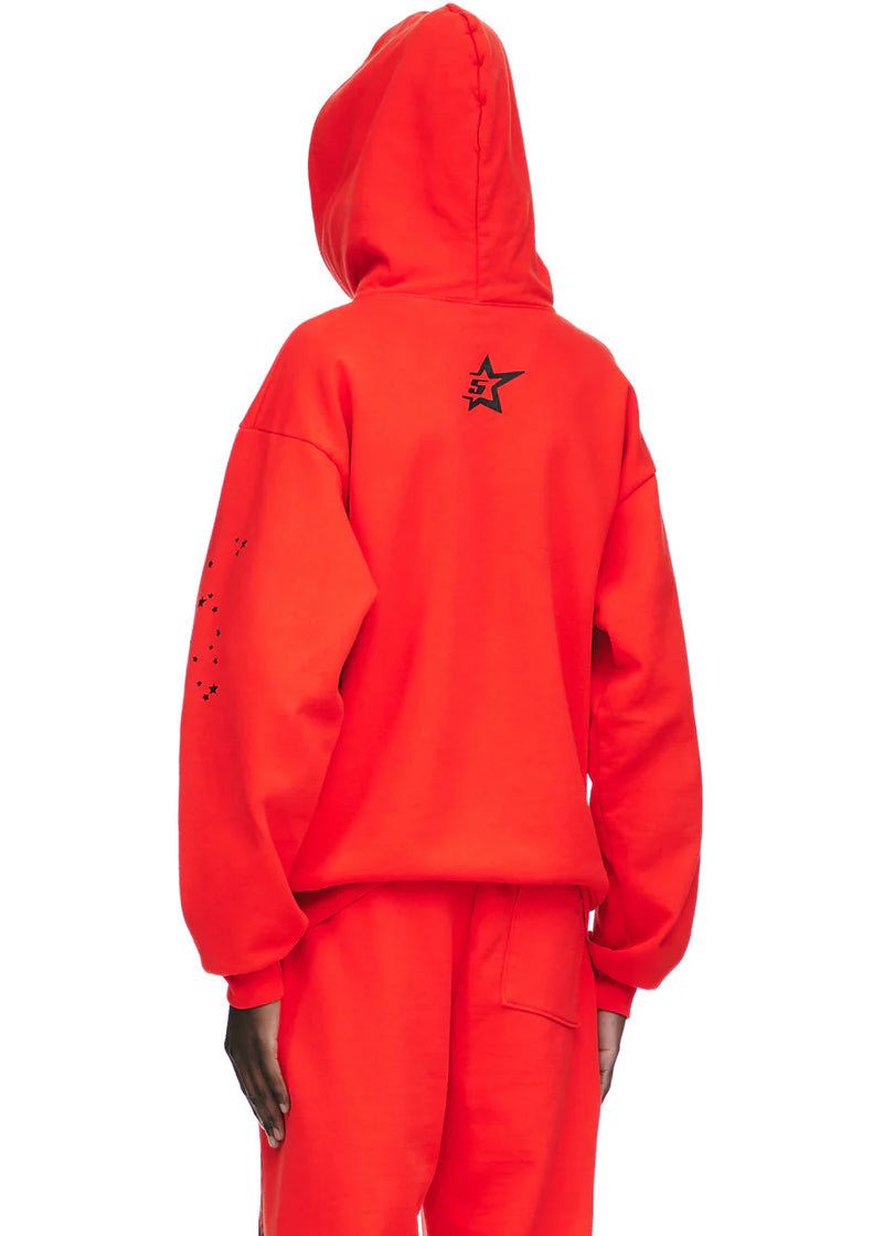Person wearing the Red Graphic Hoodie with Spider Web Print and Star Details – Comfort Fit Pullover Hoodie, seen from the back. The hoodie shows a black star on the upper back and black dots on the left sleeve for a bold streetwear look.