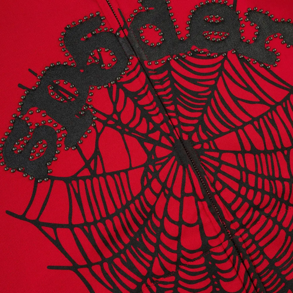Close-up of the Red Sp5der Web Zip Hoodie 440GSM, featuring a black studded spider web graphic and "sp5der" in black letters.