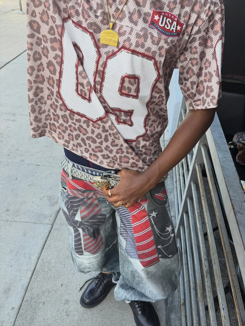 Leopard print varsity mesh jersey with oversized number 98 and USA patch, styled with baggy graphic jeans