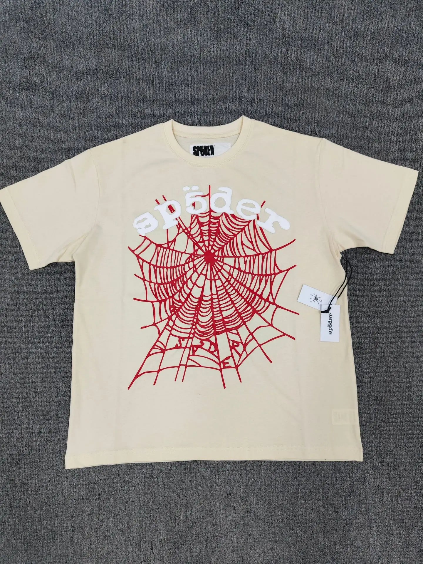 Sp5der beige short sleeve t-shirt with red spider web graphic and white Sp5der logo print on the front