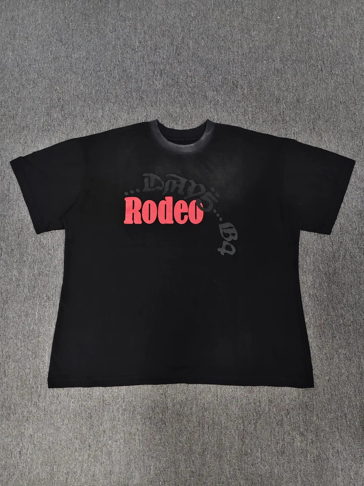 Sp5der Rodeo black oversized graphic t-shirt with red Rodeo lettering print and tonal dark text overlay