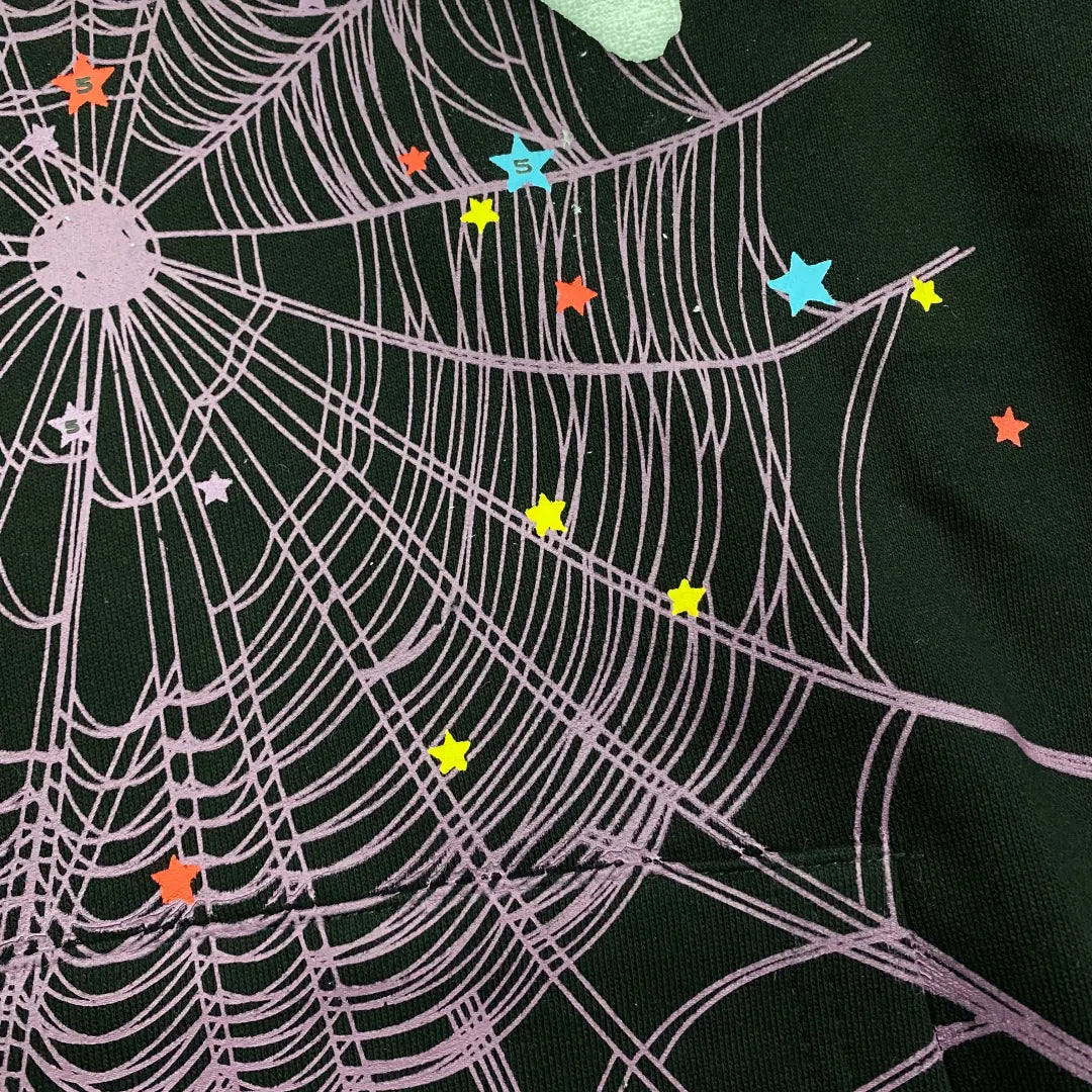 The Black Sp5der Web Hoodie 440GSM features a bold purple web on black, accented with white stars—giving this Core Spider Hoodie a vibrant, playful look.