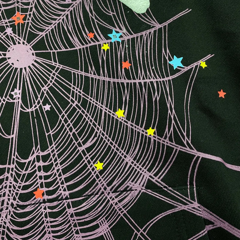 The Black Sp5der Web Hoodie 440GSM features a bold purple web on black, accented with white stars—giving this Core Spider Hoodie a vibrant, playful look.