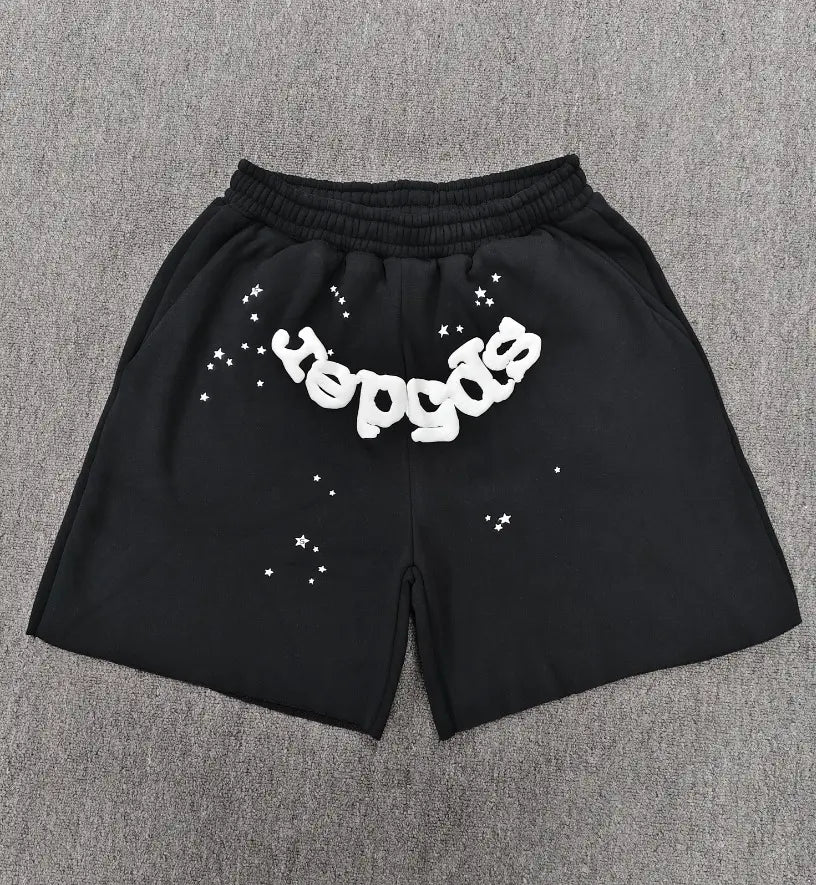 Black Sp5der jogger shorts with white puff-print letter graphic and star print on the front
