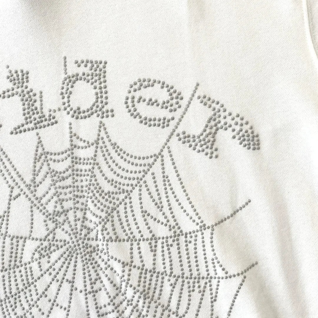 The White Sp5der Crystal Web Hoodie 440GSM features a crystal web and 'Sp5der' design in silver rhinestones, combining luxury streetwear style with standout detailing on a premium white hoodie.