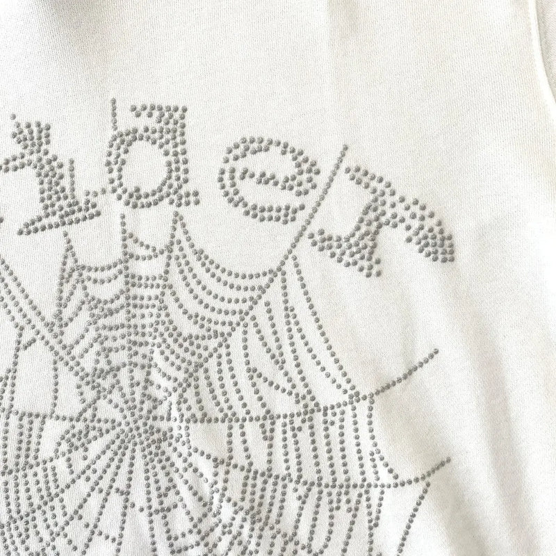 The White Sp5der Crystal Web Hoodie 440GSM features a crystal web and 'Sp5der' design in silver rhinestones, combining luxury streetwear style with standout detailing on a premium white hoodie.