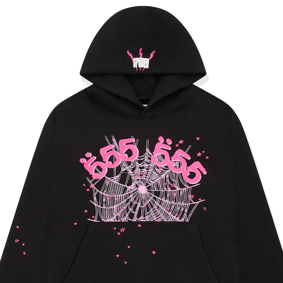 The Sp5der 555 Hoodie – Black & Pink Web 440GSM Heavyweight Streetwear Pullover features Y2K-inspired graphics: a white hand, pink arms, pink "555" and "Ü" on the chest, plus a white spider web and small pink stars for luxury streetwear fans.