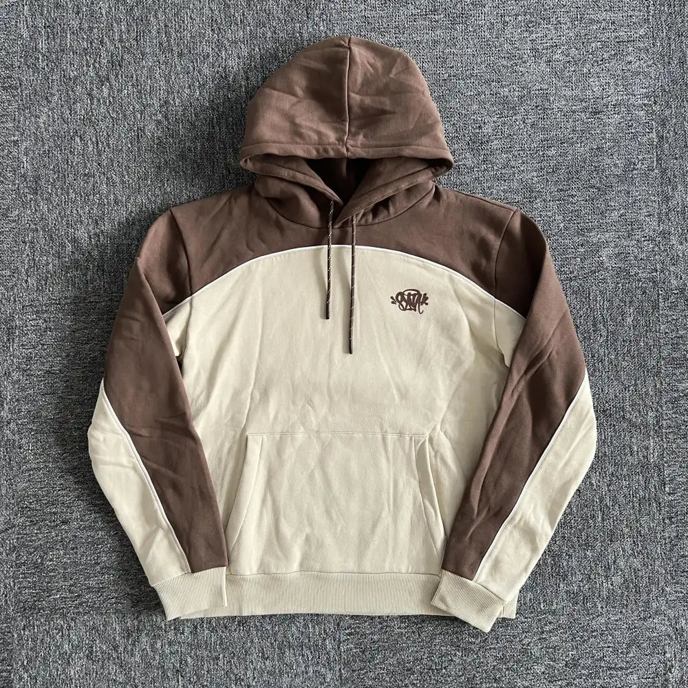 Syna World brown and beige two-tone pullover hoodie with chest letter logo print laid flat